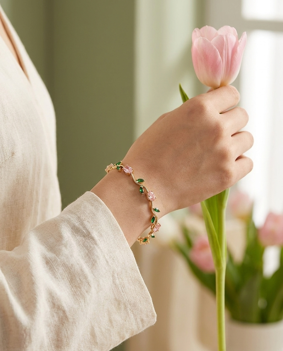 Vrouw draagt de Fleurelle Tulp Armband om haar pols terwijl ze een roze tulp vasthoudt